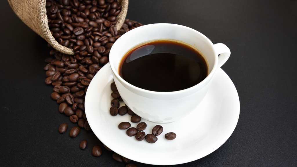 black coffee on table with coffee beans